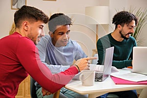Group of university colleagues studying together at shared students house.