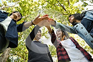 Group of university friends stacking hands together. Human relationship, social, community and cback to school concept