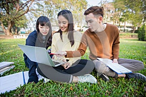 Group Of University Students asian sitting on the green grass W