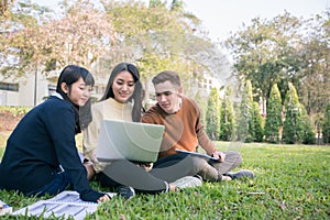 Group Of University Students asian sitting on the green grass W