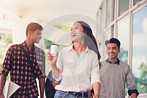 Group of university students walking outside together in campus, Happy Diverse students team concept.