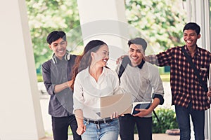 Group of university students walking outside together in campus, Happy Diverse students team concept.