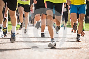 Group of unrecognizable runners outdoors. Long distance running.