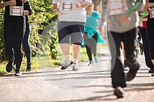 Group of unrecognizable runners outdoors. Long distance running.