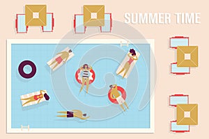 Group of vacationers swims in pool on inflatable rings or rafts. Parasols and sun loungers around pool. Concept of resting in