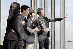 Group of variety LGBTQ, man and woman and transgender standing drinking coffee and taking and looking together to far point