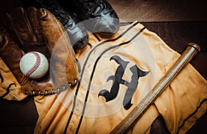 Vintage baseball gear on a wooden background