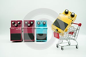 Group of vintage guitar pedals and shopping cart