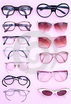 Group of vintage man and woman spectacles on pink back