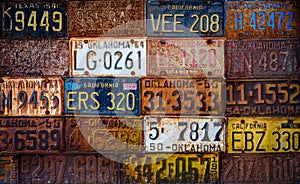 A group of vintage, rusty license plates