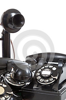 A group of vintage telephones on a white background