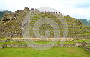 Group of Visitors Exploring the Amazing Inca Citadel Ruins of Machu Picchu, UNESCO World Heritage Site in Cusco Region of Peru