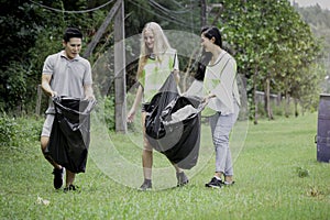 Group of volunteer collecting trash garbage, holding garbage bag, clean up area of dirty, environmental charity concept