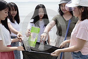 Group of volunteers cleans beach out of plastic gabbage