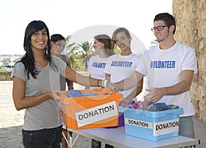 Group of volunteers collecting clothing donations