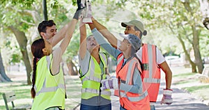 Group of volunteers high five after cleaning the park. Cheerful council workers or activist cheering after a job well