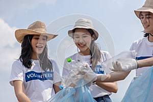 Group of volunteers holding rubbish bags collecting plastic bottles in bags. clean up garbage in tourist attractions. Conservation