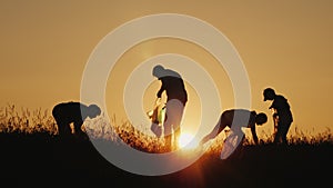 A group of volunteers picks up trash in nature. Clean environment concept