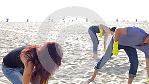 Group Of Volunteers Tidying Up Rubbish On Beach