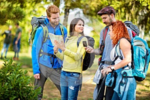 Group of walkers in forest pointing something