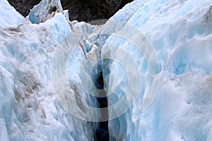 Group walking inside a crack in Franz josef glacier