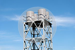 Group of Water tower rising from trees against blue sky,Constructed at a height sufficient to pressurize a water supply system