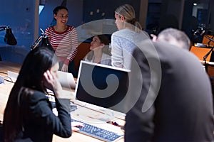 Group of web designers developing a cybersecurity website, app or software late at night in the office