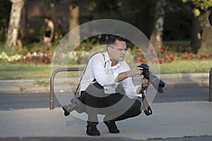 A group of wedding photographers on the streets of Budapest is holding a photo session for a couple of newlyweds.