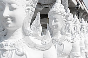 Group of white Deva statue standing.