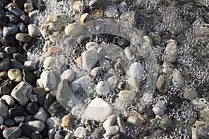 Group of white, grey and light brown stones background, pebbles beach