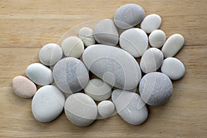 Group of white and grey pebbles, one by ony, simplicity stone background, flat lay texture in daylight