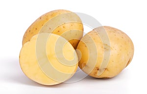 Group of whole and sliced raw potatoes isolated on white background close up