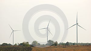 Group of wind power plants on agricultural fields.