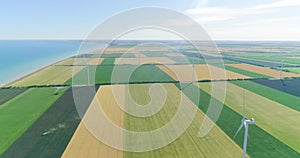 Group of windmills for electric power production in the agricultural fields. Aerial view