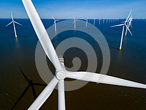 A group of windmills floats gracefully on top of tranquil waters in the Netherlands Flevoland,