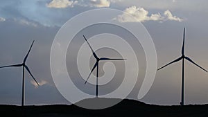 Group of windmills for renewable electric energy production. Production of green energy with wind and mills to stop global warming