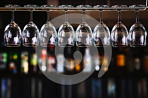 Group of wine glasses hanging above a bar rack in pub & restaurant