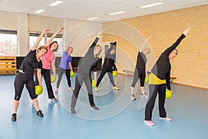 Group of women with balls doing stretching exercises