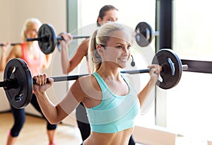 Group of women with barbells in gym photo