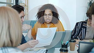 Group of women colleagues talking brainstorming sharing ideas working at table in office