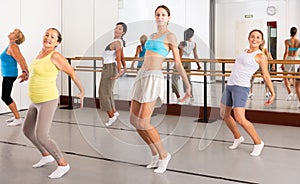 Group of women different ages training sport dance in studio