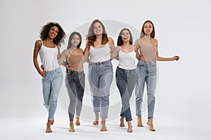 Group of women with different body types on background