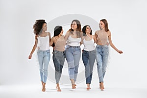 Group of women with different body types on background