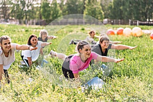 Group of women doing fitness on the grass