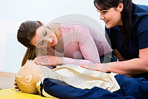 Group of women in first aid class exercising reanimation