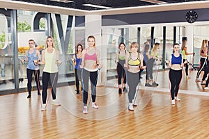 Group of women in fitness club with resistance band