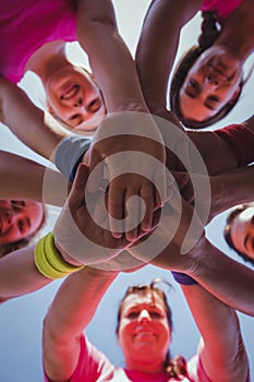 Group of women forming hand stack in the boot camp photo