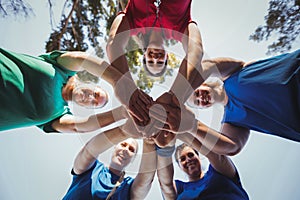 Group of women forming hand stack in the boot camp photo