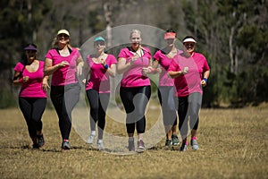 Group of women jogging together in the boot camp photo