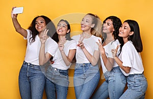 Group Of Women Making Selfie On Mobile Phone, Yellow Background
